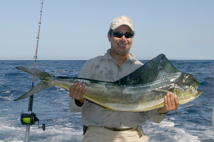 a man holding a fish in the water