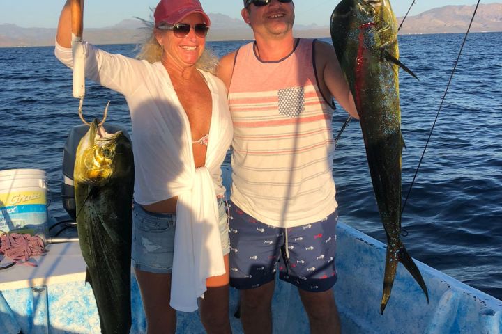 a person holding a fish on a boat