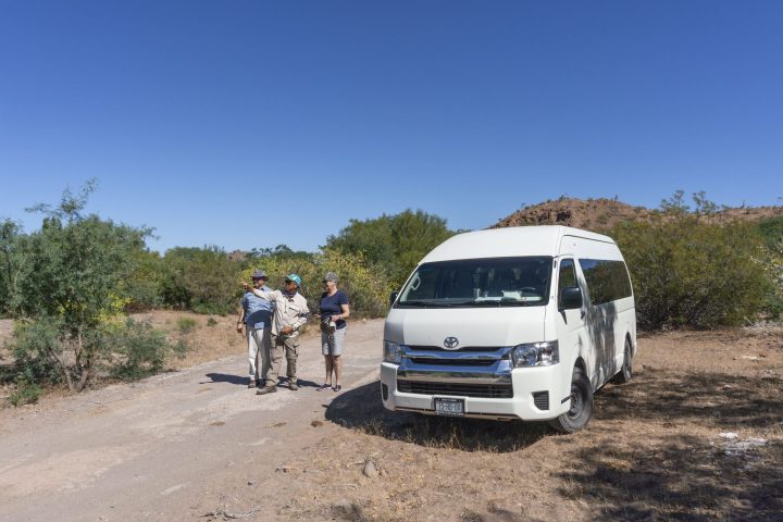 a truck driving down a dirt road